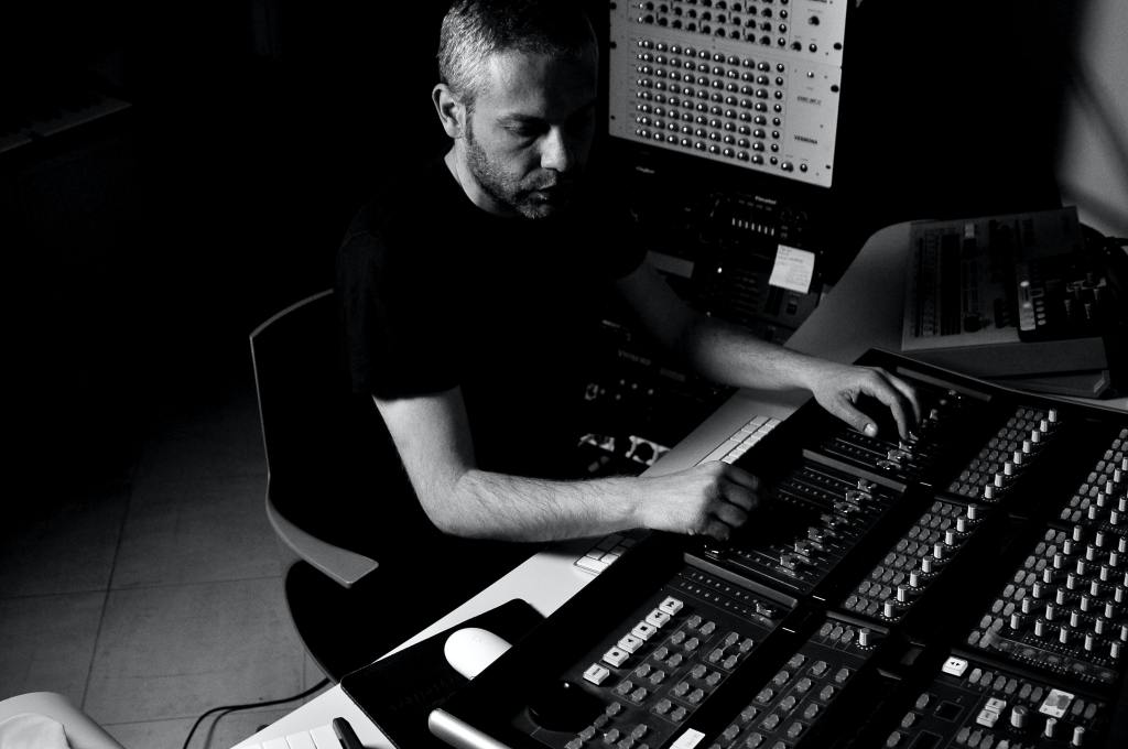 Sound Engineer operating a mixing desk.